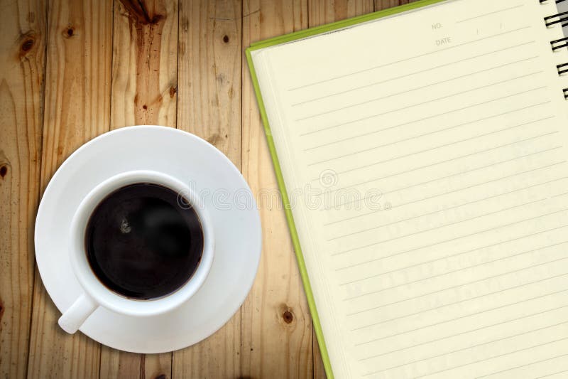 Offee and white sketch book on wood table