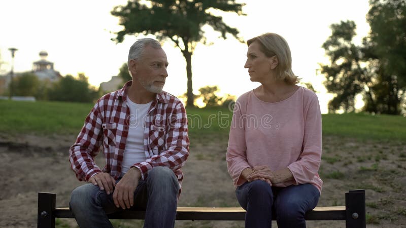 Offended senior couple sitting on bench and looking at each other, relationships royalty free stock photos Offended senior couple sitting on bench and looking at each other, relationships royalty free stock photos
