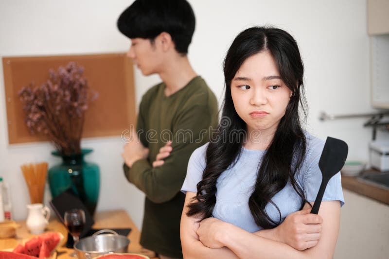 Offended Young Woman Ignoring Her Upset Husband after Quarrel in