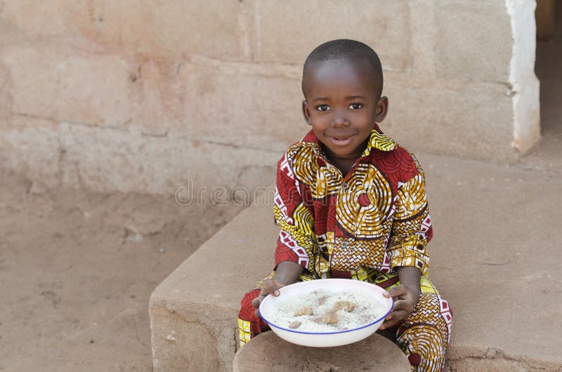 Offener Schuss des kleinen Schwarzafrikaner-Jungen, der draußen Reis isst