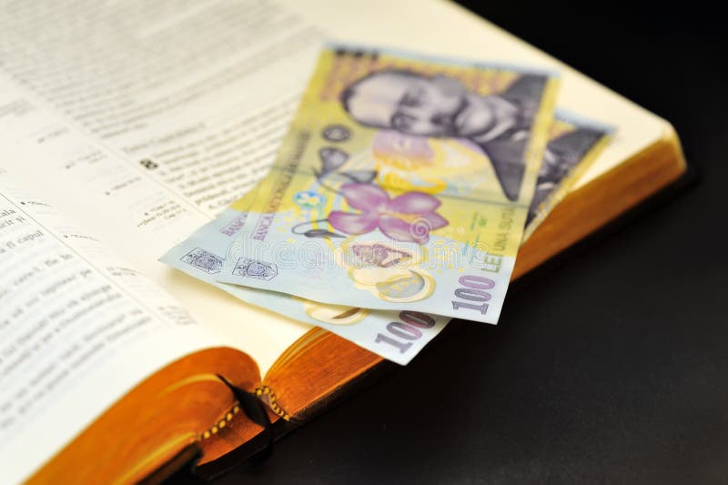 Offering romanian currency and holy bible stock image