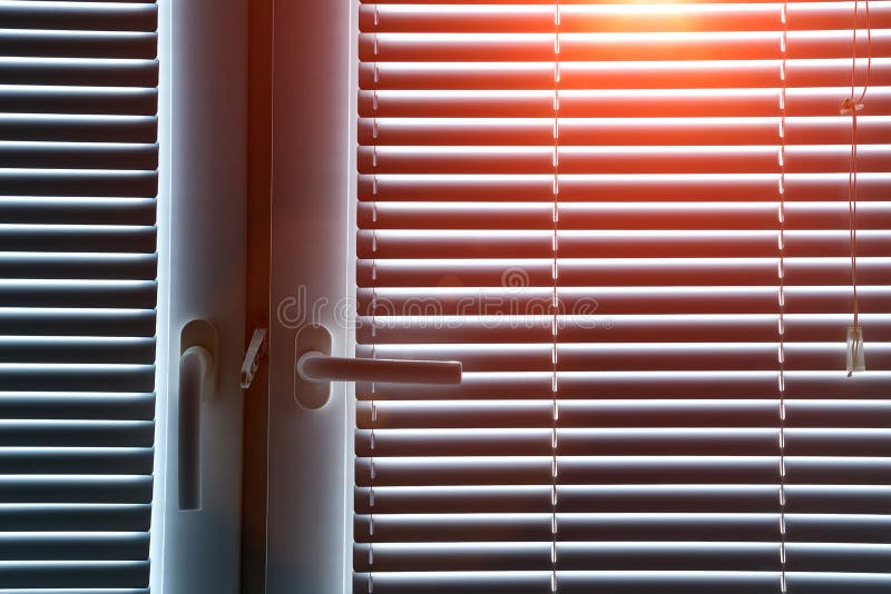 Aluminum blinds on the office windows. Made from metal. Modern sun protection and window decoration.
