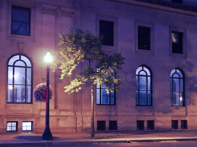 Office building illuminated by street light royalty free stock image