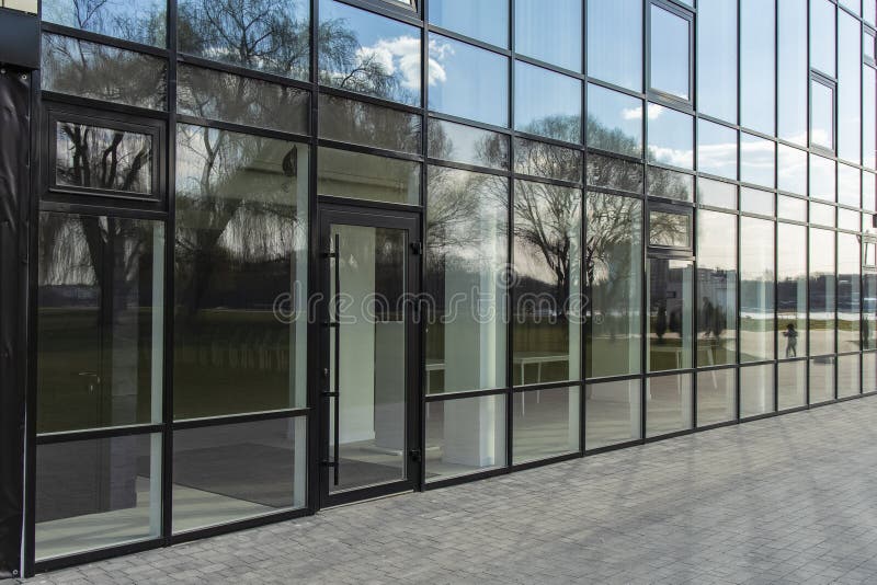 Office center glass exterior wall building paved street walk side urban modern architecture background