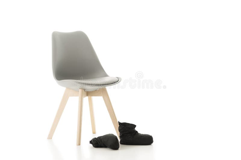 Office Chair and Pair of Back Shoes on White