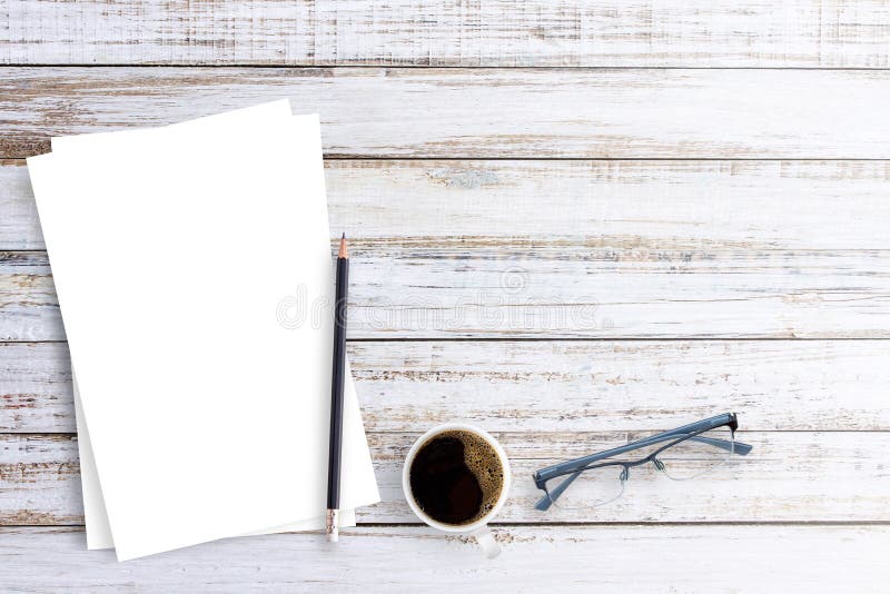 Office desk glasses,pencil,coffee cup and white paper on a white