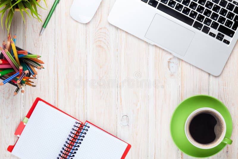 Office desk table with computer, supplies, coffee cup and flower royalty free stock photo