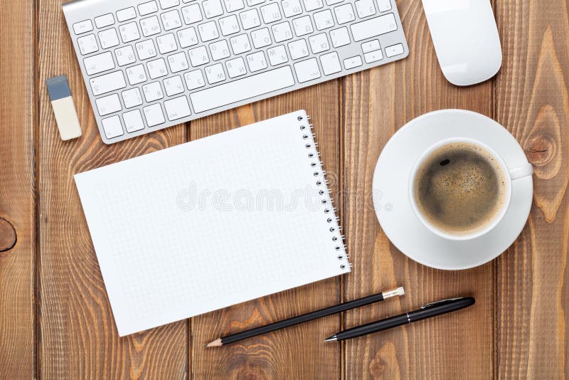 Office desk table with computer, supplies and coffee cup. Notepad, calendar.