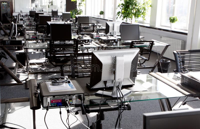 Office desks with computers in corporate interior