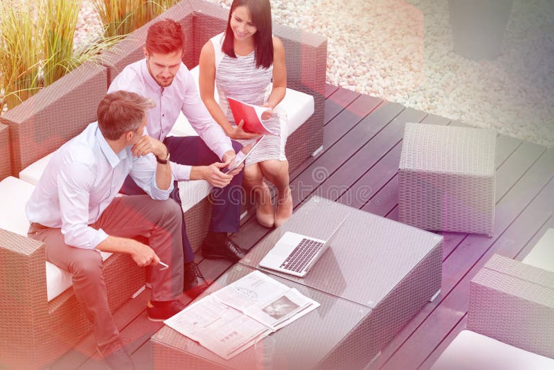 High angle view of colleagues with technology sitting at office terrace royalty free stock photo High angle view of colleagues with technology sitting at office terrace royalty free stock photo
