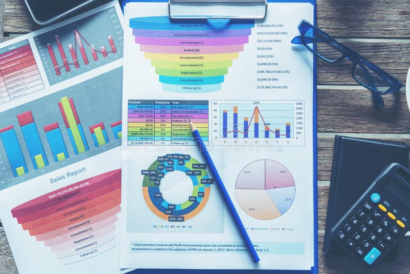 Office laptop business financial document chart and graph on wooden table with coffee cup. Flat lay notebook computer laptop on stock photos