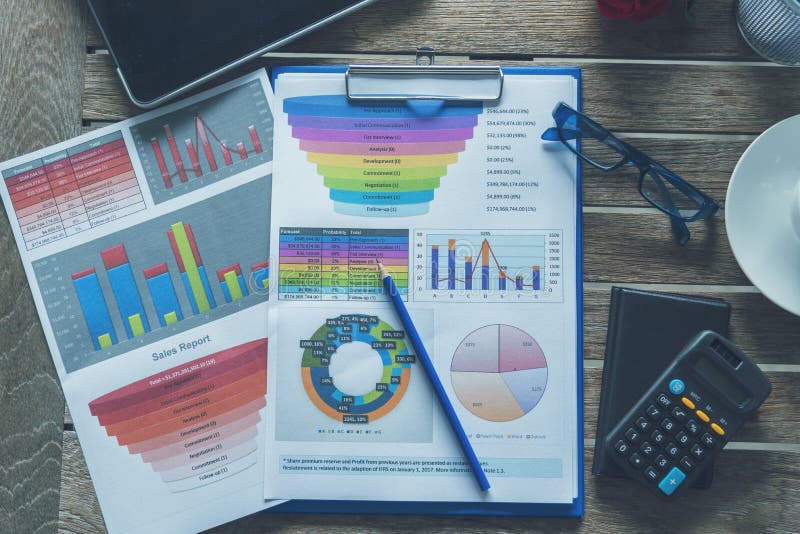 Office laptop business financial document chart and graph on wooden table with coffee cup. Flat lay notebook computer laptop on stock image
