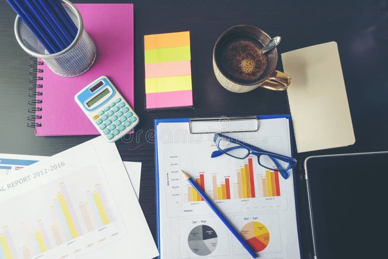 Office laptop business financial document chart and graph on wooden table with coffee cup. Flat lay notebook computer laptop on stock photography