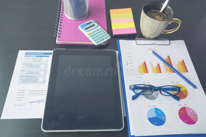 Office laptop business financial document chart and graph on wooden table with coffee cup. Flat lay notebook computer laptop on royalty free stock image