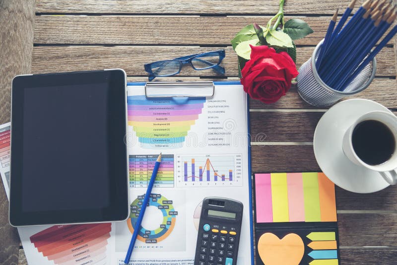 Office laptop business financial document chart and graph on wooden table with coffee cup. Flat lay notebook computer laptop on office desk. No people business graph chart mockup on business workspace