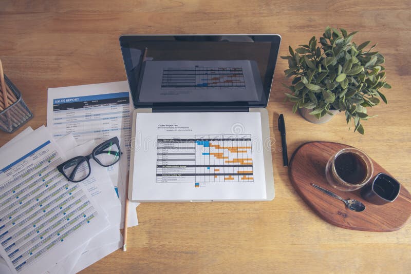 Office laptop business financial document chart and graph on wooden table with coffee cup. Flat lay notebook computer laptop on stock images