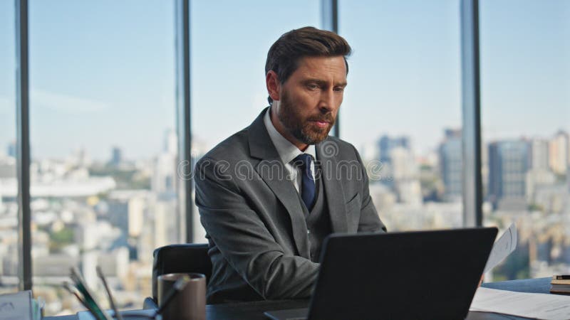 Office manager talking computer at desk closeup. Busy middle aged ceo working royalty free stock photography