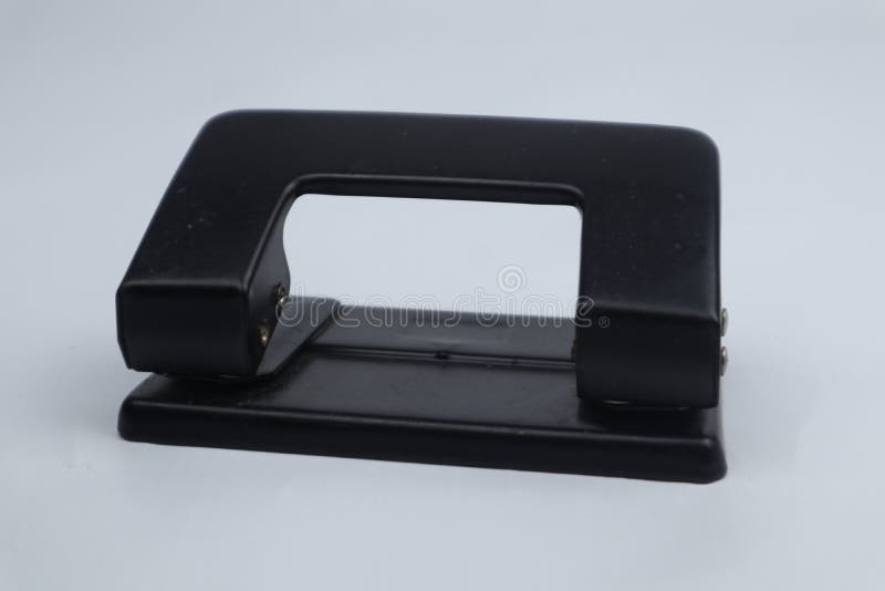Black paper hole puncher, office tool equipment that is used to create  holes in sheets of paper, isolated on a white background, with clipping  path Stock Photo