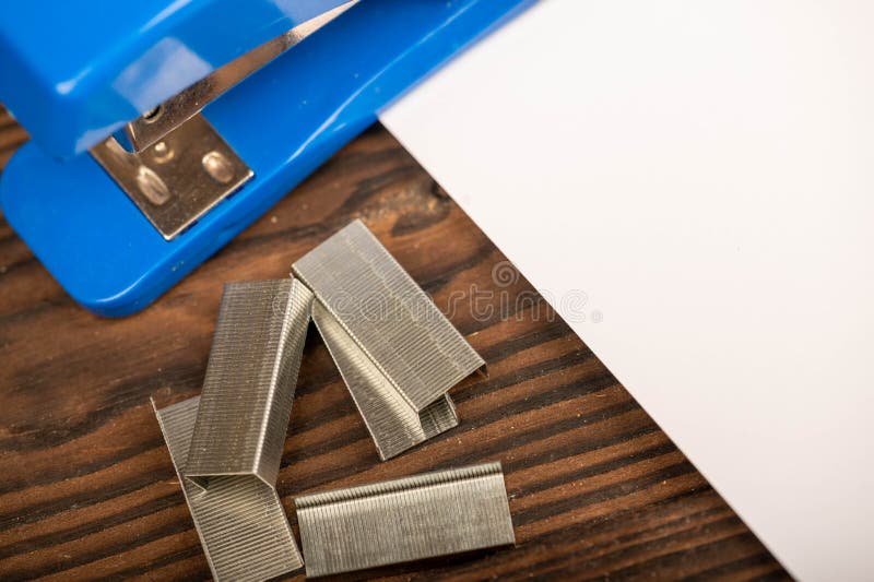 Office Stapler, Stapler Staples and White Paper on the Table, Closeup