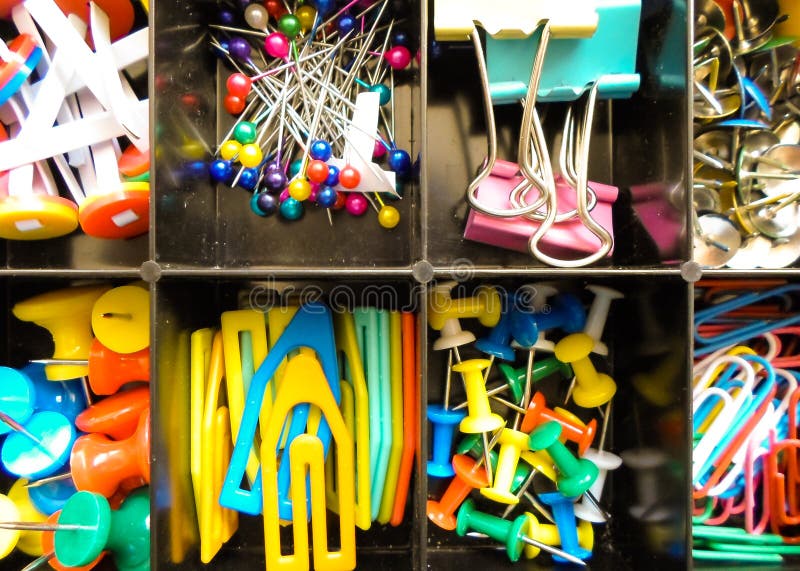 Office supplies in a box, set of stationery, multicolored paper clips and buttons stationery