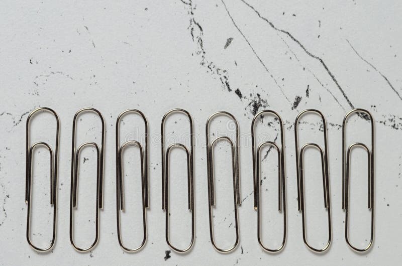 Office Supplies, Nickelplated Paper Clips on the Textured Surface of