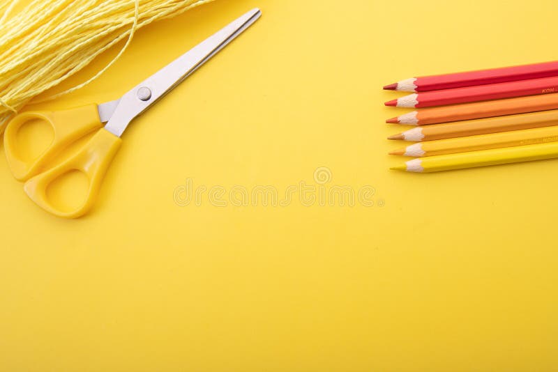 So prepared pencil crayons on a yellow background along with other tools. Background for office work. So prepared pencil crayons on a yellow background along with other tools. Background for office work.