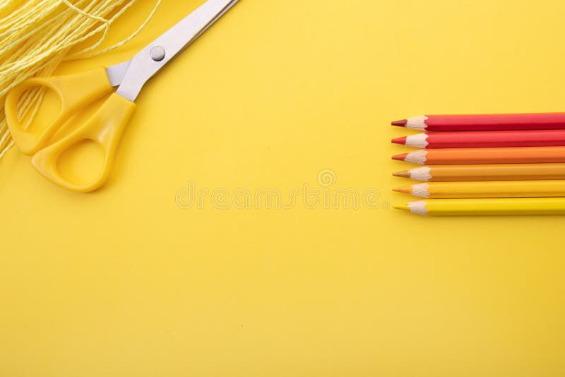 So prepared pencil crayons on a yellow background along with other tools. Background for office work. So prepared pencil crayons on a yellow background along with other tools. Background for office work.