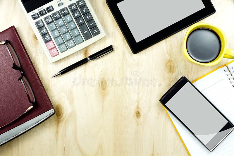 Office table desk top view with smart device, working wood table.