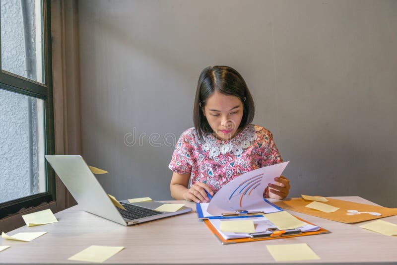Office woman checking financial report documents in the office royalty free stock photography Office woman checking financial report documents in the office royalty free stock photography