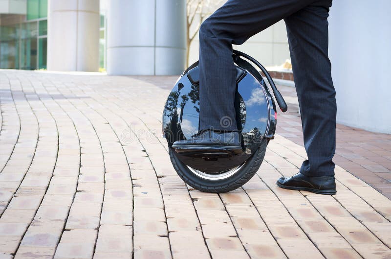Office Worker is Driving on an Electric Mono Wheel, Side View Stock Photo -  Image of invention, moving: 143225790
