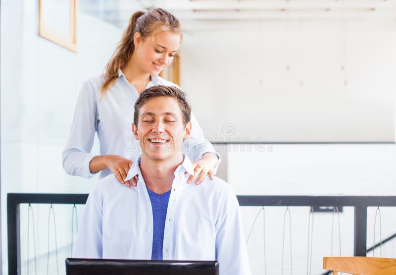 Office worker getting massage on his workplace stock image Office worker getting massage on his workplace stock image