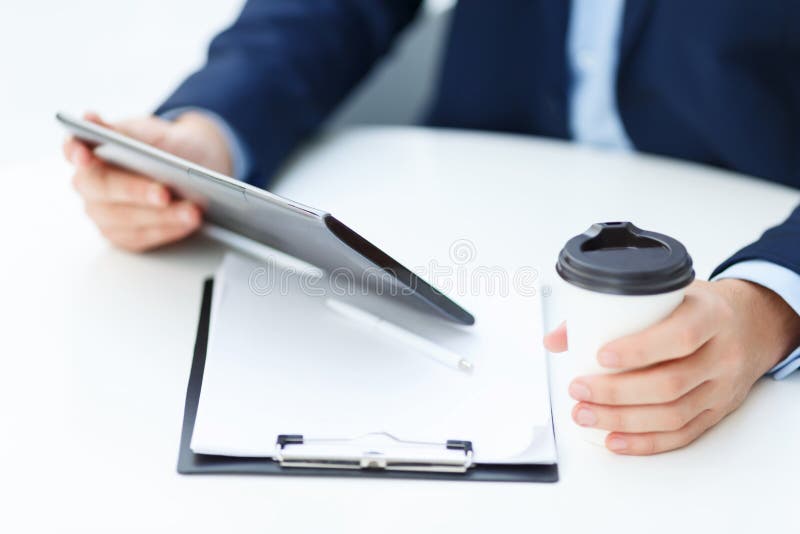 Office worker with tablet and papercup of coffee