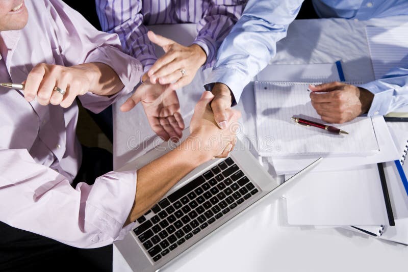 Three office workers working together on project, shaking hands and clapping. Finished project or solved a problem. Boardroom table clapping stock images, royalty-free photos and pictures