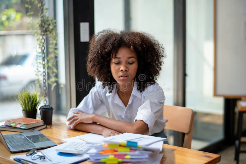 Sitting Work Hard and Look at the Pile of Work with Exhaustion Stock