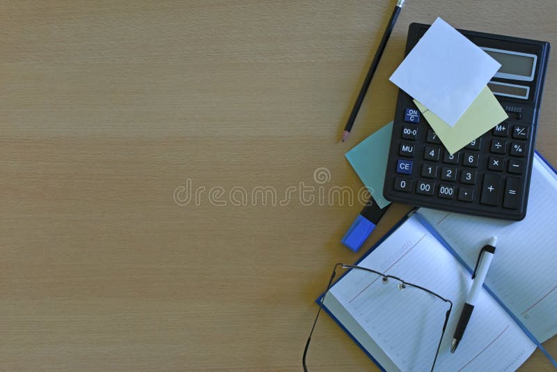 Office workplace with text space, Wooden table with office supplies tablet, desktop computer and book, top view, over light