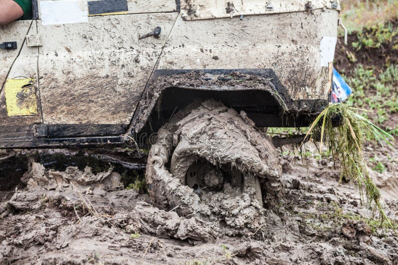 Offroad Car Stuck in Deep Mud with Flat Tyre. Stock Photo Image of