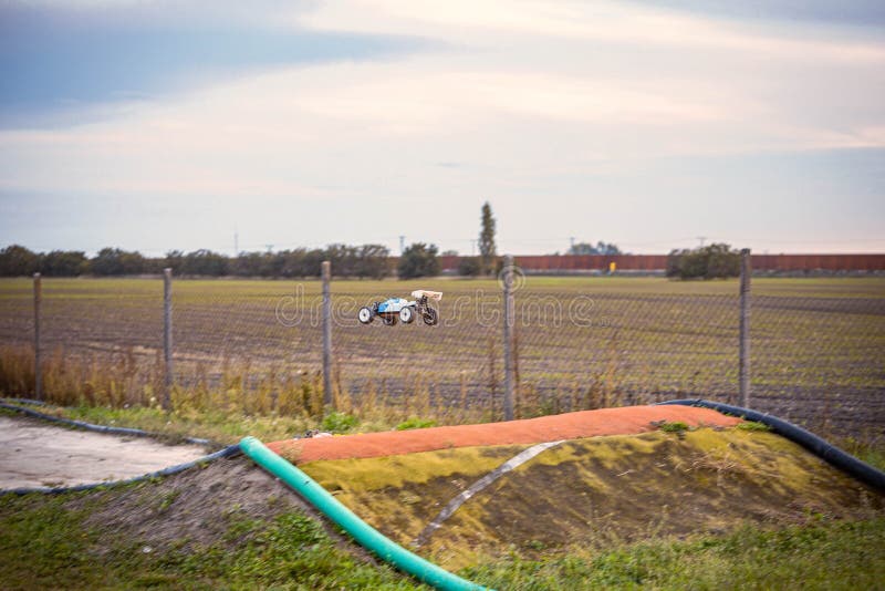 Offroad RC buggy driving on an outdoor dirt track