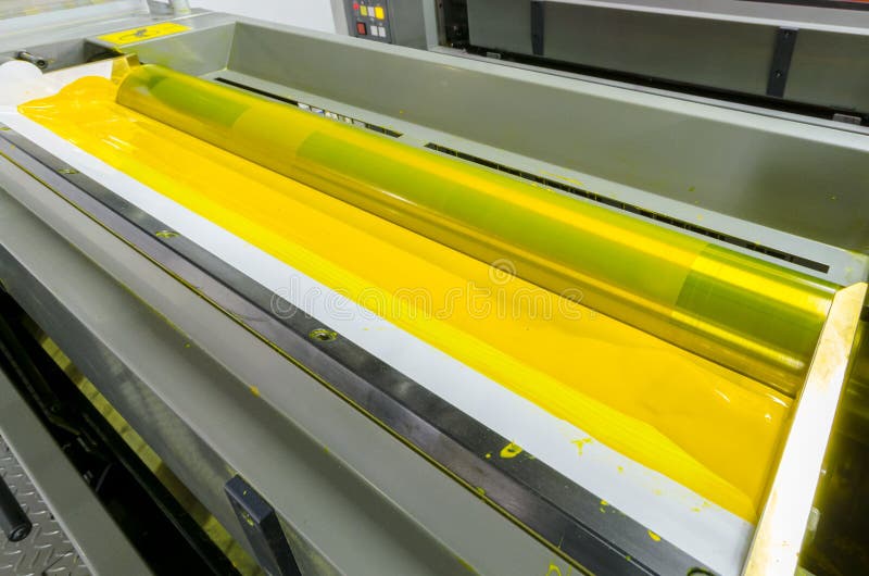 Offset machine printing press yellow ink rollers stock image