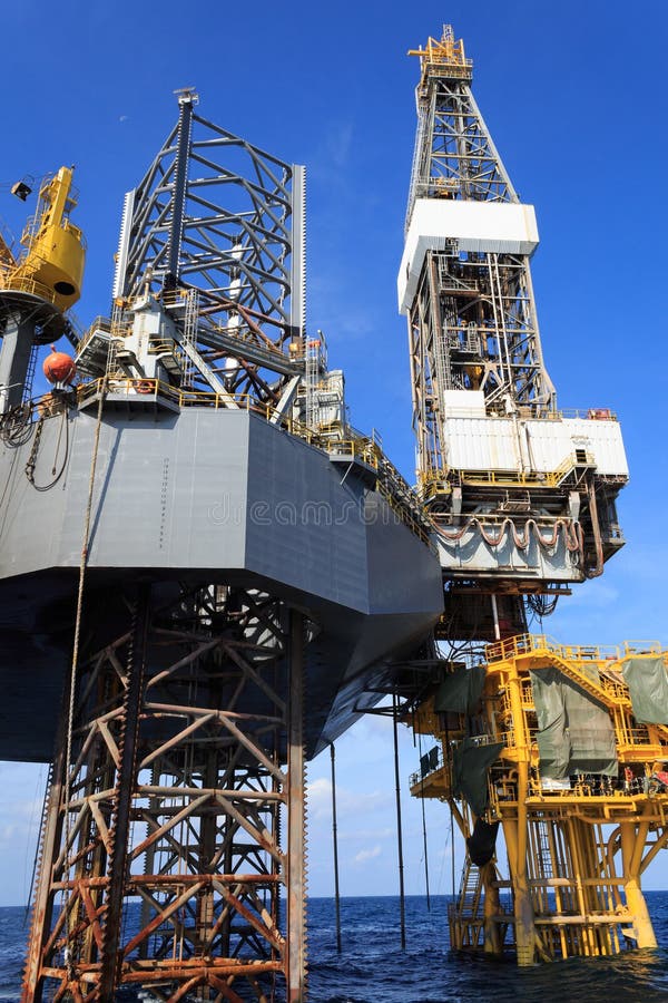 Offshore Jack Up Drilling Rig Over the Production Platform Stock Photo