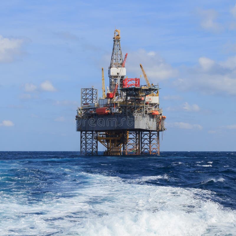 Offshore Jack Up Drilling Rig Over the Production Platform Stock Image