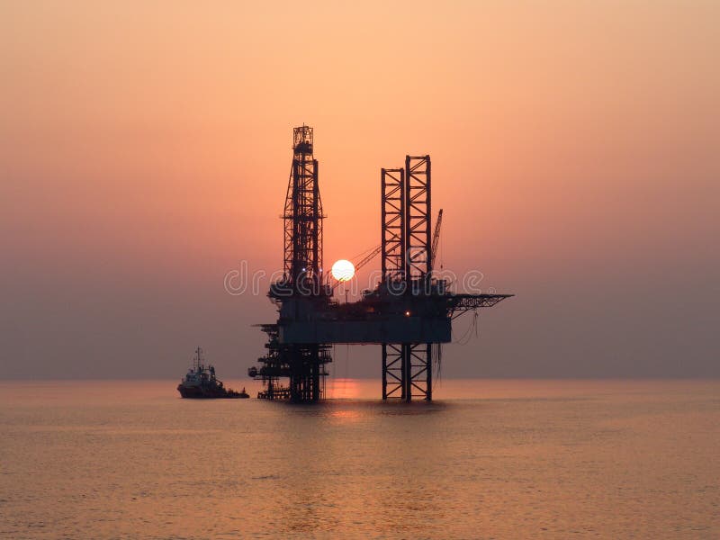 Sunset in some oil field at Persian Gulf-oil rig and offshore work boat. Sunset in some oil field at Persian Gulf-oil rig and offshore work boat