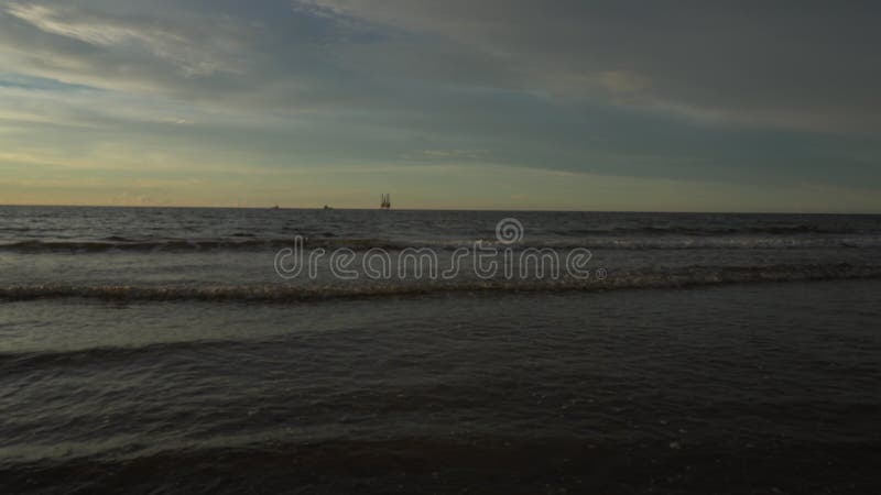 Offshore oil and rig platform on horizontal line in sunset time. Construction of production process in the sea stock video