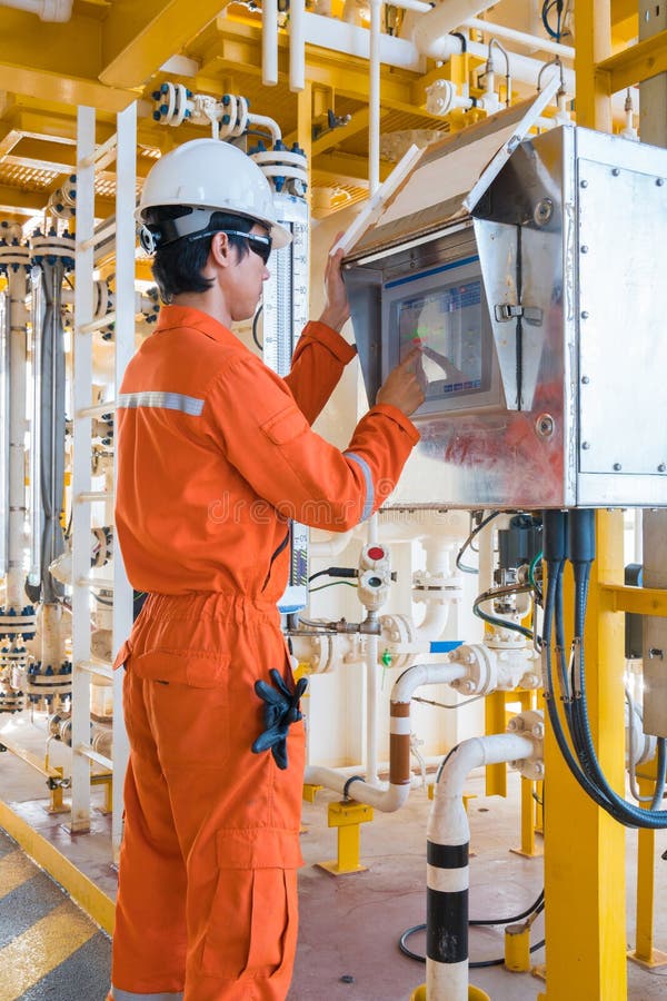 Offshore oil rig worker, Production operator operate valve by using touch screen panel to command open and close valve royalty free stock photos Offshore oil rig worker, Production operator operate valve by using touch screen panel to command open and close valve royalty free stock photos