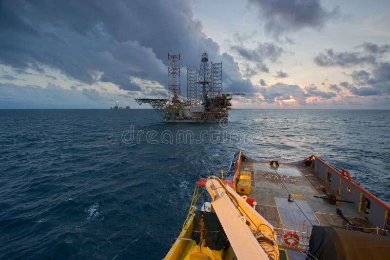 An offshore vessel during towing operation of an oil platform stock image