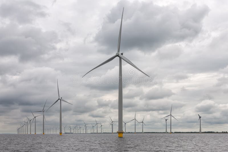 Large offshore windfarm near Dutch coast with cloudy sky. This park in the lake IJsselmeer near Urk is the biggest windfarm of the Netherlands