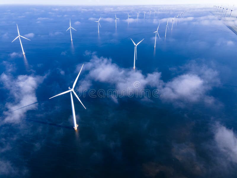 offshore windmill park with clouds and a blue sky, windmill park in the ocean aerial view with wind turbine Flevoland Netherlands Ijsselmeer. Green energy. offshore windmill park with clouds and a blue sky, windmill park in the ocean aerial view with wind turbine Flevoland Netherlands Ijsselmeer. Green energy