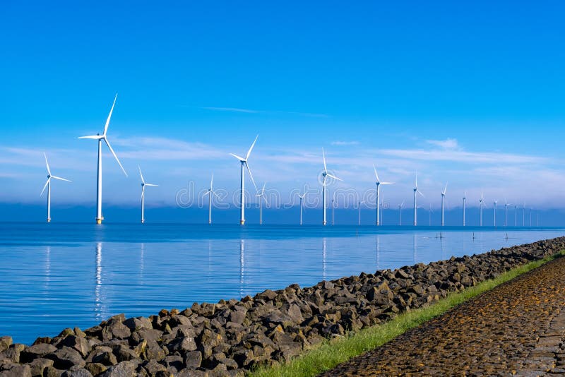 offshore windmill park with clouds and a blue sky, windmill park in the ocean aerial view with wind turbine Flevoland Netherlands Ijsselmeer. Green energy. offshore windmill park with clouds and a blue sky, windmill park in the ocean aerial view with wind turbine Flevoland Netherlands Ijsselmeer. Green energy