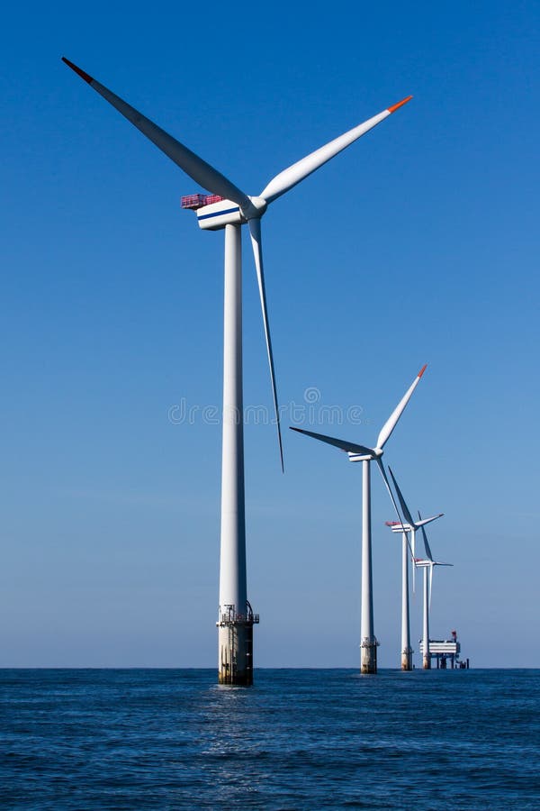 Offshore windturbines whit transformer platform in background. Offshore windturbines whit transformer platform in background