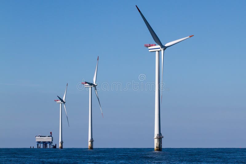 Offshore windturbines whit transformer platform in background. Offshore windturbines whit transformer platform in background