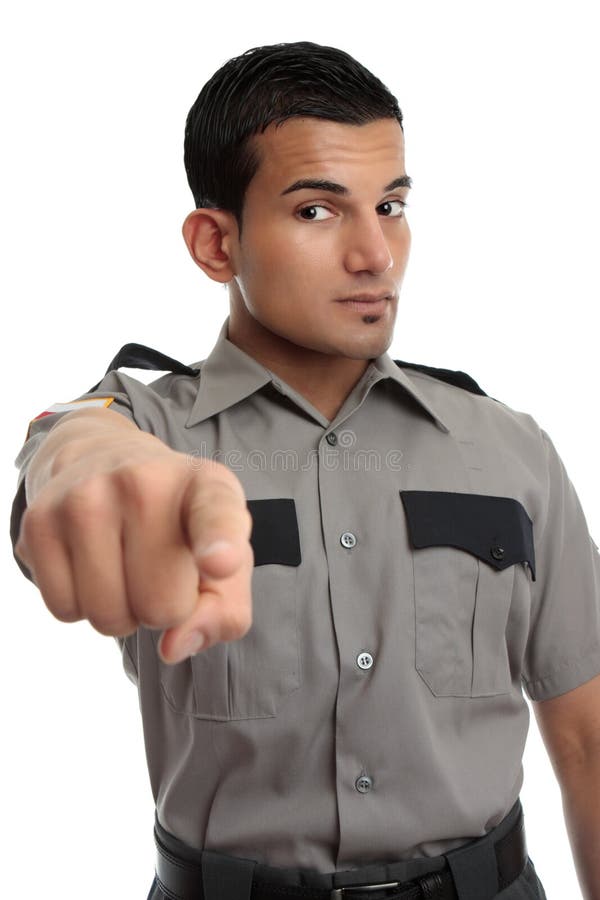 A security guard, prison officer or other similarly dressed occupation. Man is pointing his finger. A security guard, prison officer or other similarly dressed occupation. Man is pointing his finger